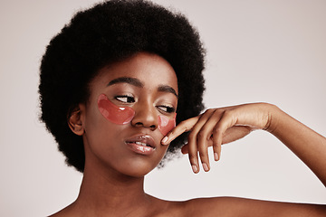 Image showing Skin care, eye mask and a black woman in studio with dermatology cosmetic product. Aesthetic model with hands for collagen gel patch for health, wellness and beauty face skin glow on grey background