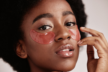 Image showing Eye, skincare and face mask portrait on black woman in studio with dermatology cosmetic product. Aesthetic model with collagen patch for health, wellness and natural facial beauty on grey background