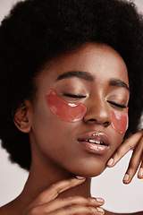 Image showing Black woman with skincare, eye or face mask in studio with dermatology cosmetic product. Aesthetic model with hand on skin for spa collagen beauty patch for health, wellness and natural facial glow