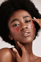 Image showing Skincare, eye mask and face portrait of black woman in studio with dermatology cosmetic product. Aesthetic model with hand on spa collagen beauty patch for health, wellness and natural facial glow