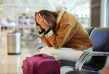 Image showing Upset woman, airport and flight delay sitting on bench in travel restrictions or plane cancelation with luggage. Angry, sad or disappointed female in frustration for missing boarding schedule time