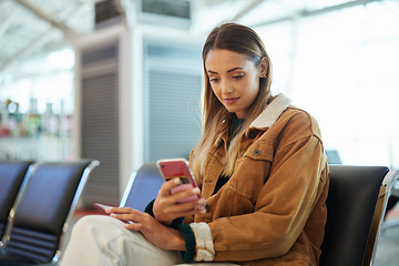 Image showing Travel, phone and woman relax at airport lobby on social media, internet browsing or web scrolling. Immigration, mobile technology and female with smartphone for networking while waiting for flight.