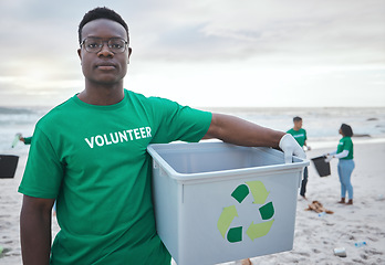 Image showing Cleaning, recycling and portrait of black man on beach for sustainability, environment or eco friendly. Climate change, earth day or nature with volunteer and plastic for charity or community service