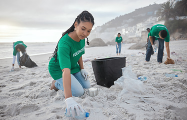 Image showing Teamwork, cleaning and recycling with black woman on beach for sustainability, environment and eco friendly. Climate change, earth day and nature with volunteer and plastic for community service