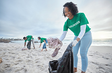Image showing Teamwork, trash and recycling with woman on beach for sustainability, environment and eco friendly. Climate change, earth day and nature with volunteer and plastic for help, energy and pollution