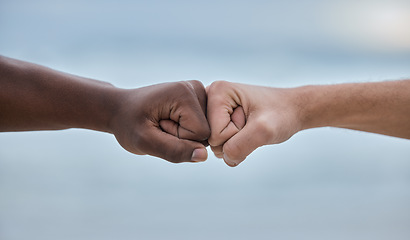 Image showing Diversity, hands and fist bump on mockup for community, trust or unity on blurred background. Hand of people bumping fists in solidarity for deal, partnership or teamwork agreement, victory or win