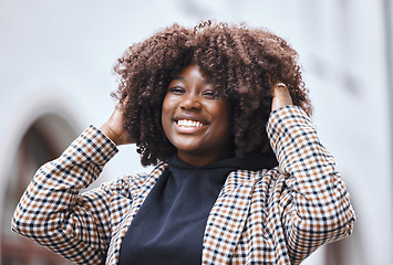 Image showing Black woman, portrait smile and afro hairstyle for fashion in city travel, trip or outdoor journey. Happy African American female touching stylish curls and smiling in happiness for traveling in town