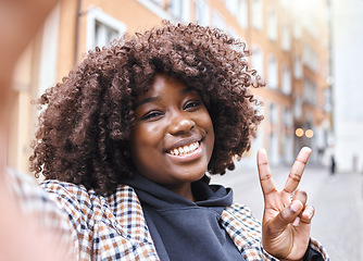 Image showing Selfie, peace sign and black woman portrait with a smile from travel in a urban city. Happy, young person and face of a African female on a holiday with freedom by a building with blurred background