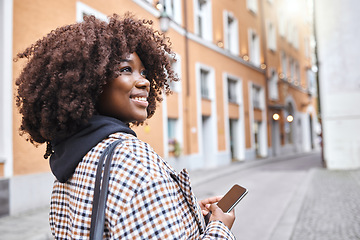 Image showing Travel, smile and black woman in street with phone, holiday sightseeing in London, happy tourist walking in road. Vacation, urban adventure and relax, 5g on walk with buildings and explore new city.