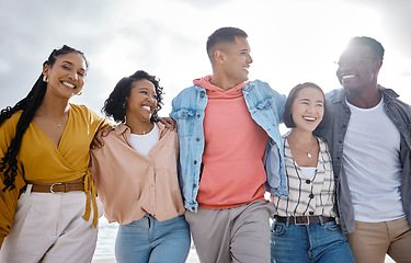 Image showing Diversity, happy and friends walking at the beach for holiday, vacation and bonding on sky background space. Men, smile and women group relax at the sea, laugh and cheerful on an ocean trip in Miami