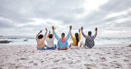 Image showing Diversity, hands up or friends on beach sand to relax on holiday, vacation bonding in nature together. Back view, men and women group relaxing at sea enjoy traveling on ocean trips in Miami, Florida