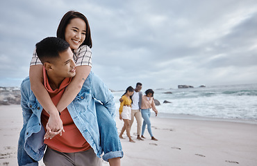 Image showing Happy, piggyback or couple of friends at a beach on a relaxing holiday vacation bonding in nature together. Love, man and Asian woman with smile at sea enjoys traveling on ocean trips in Miami, USA