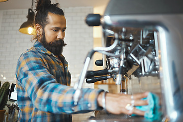 Image showing Man in coffee shop, barista cleaning machine for drink with focus and small business, workflow and process. Clean up are espresso, latte or cappuccino production, cafe with hygiene and disinfection