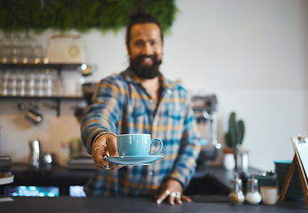 Image showing Cafe, serving and man barista with a coffee for a customer in his small business restaurant. Happy, smile and male waiter or server giving a cup of cappucino, latte or espresso in his cafeteria shop