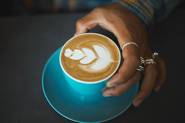 Image showing Latte art, coffee and barista hand with leaf design, caffeine and artistic product with pattern in cafe. Creative, man and drawing with milk foam, hospitality with service and beverage closeup