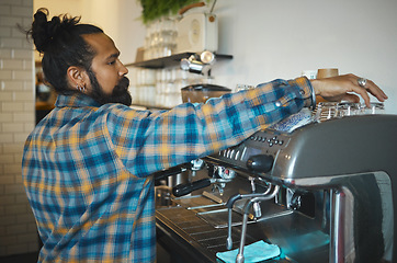 Image showing Man in cafe, barista and machine for drink with focus and small business, workflow and process. Clean up are espresso, latte or cappuccino production, coffee shop with hygiene and disinfection