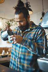 Image showing Barista man, coffee shop and milk for drink service at small business with focus, care or experience. Young entrepreneur, cafe and expert with latte, cappuccino or tea for energy, health and wellness