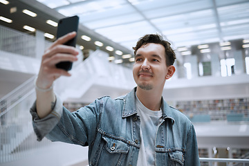 Image showing Selfie, campus and man in library for research update, social media or blog post with live streaming his experience. Education, study and phd person in university with smile for profile picture