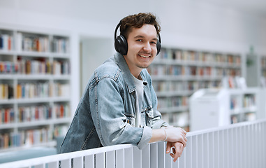 Image showing Headphones, library and student portrait for university, college or campus listening to music in study education. Research, learning and bookshelf with happy person or man on audio technology podcast