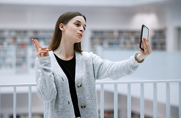 Image showing Selfie, library and woman with peace sign for social media, influencer blog post or studying update for gen z lifestyle. Emoji hands person or student profile picture in university, campus or college