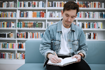 Image showing College student man, library and writing on sofa with ideas, vision and focus on education at academy lounge. University, pen and notebook for notes, goals and studying for exam, research and task