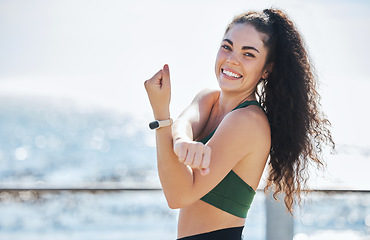 Image showing Fitness, stretching and portrait of woman at beach for running, exercise and cardio or wellness, sport and body. Face, stretch and workout run by girl at ocean training, happy or warm up routine