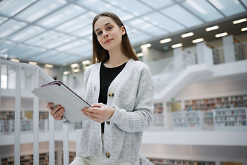 Image showing University, student portrait or woman with tablet in library for research, education or learning. Bookshelf, smile or girl on tech for scholarship, search or planning school project at collage campus