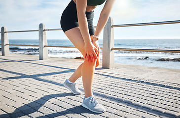 Image showing Sports woman, knee pain or red glow by beach fitness, ocean workout or sea training in healthcare wellness crisis. Legs injury, hurt or body stress for runner with burnout on medical anatomy