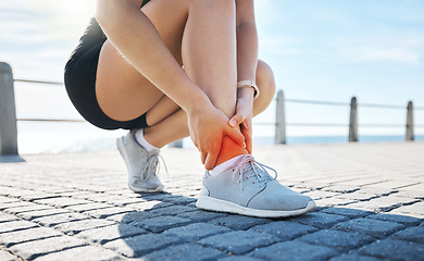 Image showing Fitness, hands or runner with ankle pain at a beach after exercising, body training injury or outdoor workout. Red glow, or injured sports athlete suffering from broken foot after running exercise