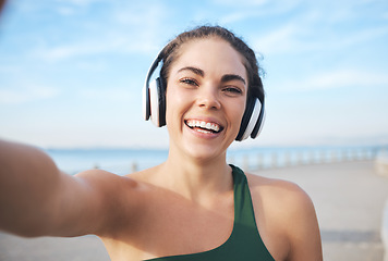 Image showing Selfie, fitness and woman headphones for outdoor training, running or exercise on video call for influencer update. Music, portrait and profile picture of sports person at beach workout or cardio