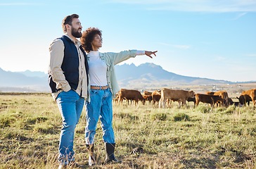 Image showing Nature, cows and couple standing on farm for sustainable, agriculture or organic livestock maintenance. Agro, farming and eco friendly interracial man and woman by field with cattle in countryside.