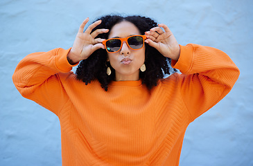 Image showing Fashion, sunglasses and black woman with kiss face, summer style and beauty with hairstyle on blue background. African American model hands with designer brand frame and trendy, stylish and pose