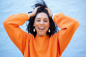 Image showing Black woman, portrait or touching fashion hairstyle on isolated blue background, mockup backdrop or wall mock up. Smile, happy or dancing student in trendy, cool or stylish clothes for youth freedom