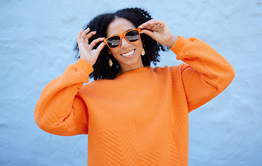 Image showing Fashion portrait, sunglasses and black woman isolated on blue background gen z, youth or trendy clothes. Happy person or beauty model in confidence, vision style and orange color on brick wall mockup