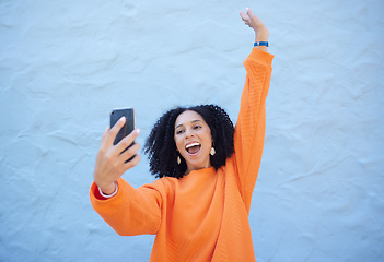 Image showing Black woman excited in selfie, smartphone and success with cheers and happiness on blue background. Influencer with social media, content creation with live streaming mockup and online achievement