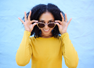 Image showing Trendy sunglasses, portrait and black woman isolated on blue background gen z, youth and fashion clothes. Summer, person or beauty model smile with vision style, yellow color and brick wall mockup