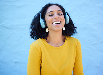 Image showing Black woman, portrait or music headphones on isolated blue background, fashion mockup or wall mock up. Smile, happy or laughing student listening to radio, audio and podcast in trendy or cool clothes