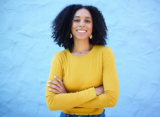 Image showing Proud, portrait and black woman in studio on mockup, space and blue background for advertising. Face, smile and girl relax on backdrop, cheerful and confident, relax and posing inside on copy space