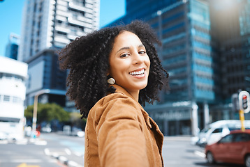 Image showing Selfie, urban city and black woman for travel, fashion influencer and outdoor journey in street with natural afro hair. Walking, carbon capture and freedom, happy and young person on road in portrait