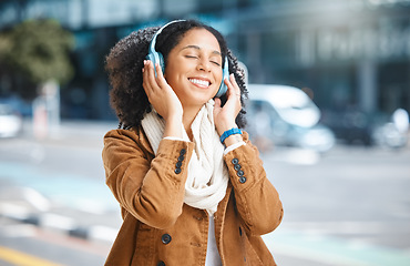 Image showing Black woman, music and headphones while happy in city for travel, motivation and mindset. Young person on urban street with radio and sound while listening and streaming podcast or audio outdoor