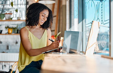 Image showing Black woman, notebook and writing in cafe, laptop planning or remote worker of freelance research in restaurant. Happy female in coffee shop, notes and computer technology for blog on social network