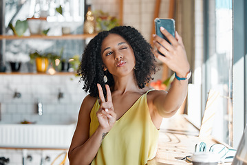 Image showing Black woman, cafe and selfie with peace sign, hands and relax for social media, app or profile picture. Young gen z girl, student and coffee shop with smartphone app, photo and happiness in morning