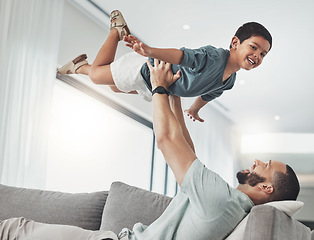 Image showing Family, dad and child in air on sofa enjoy playing on holiday, vacation and weekend in living room. Love, childhood and happy face of boy in father arms for bonding, quality time and relax at home