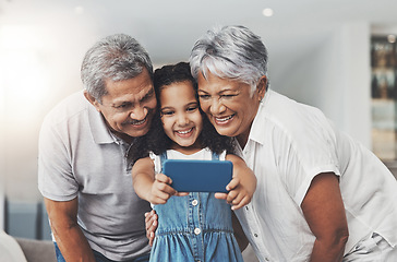 Image showing Love, happy and girl taking selfie with her grandparents in the lounge of modern family home. Happiness, smile and excited child taking picture with grandmother and grandfather at a house in Mexico.