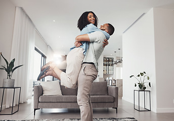 Image showing Love, man pick up woman and in living room for happiness, loving and celebration for relationship. Portrait, couple or male hug female in lounge, joyful or achievement with smile, relax or cheerful