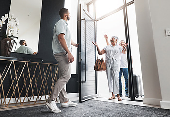 Image showing Man opening door, family visit and holiday with smile, loving and bonding together, care and vacation. Love, male invite parents into home and happiness with joy, excited and welcome with greeting