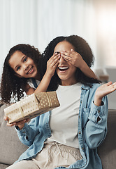 Image showing Mother, girl and surprise with gift on sofa in living room for birthday party or event. Family love, wow and portrait of kid surprising happy mama with present box for mothers day on couch in house.