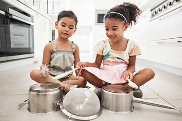 Image showing Girl children are playing house, pots as drums and happy, care free at family home and make believe with music fun. Noise, metal and kids on floor, play date together and fantasy with imagination