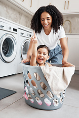 Image showing Mom, laundry and girl kid in basket by washing machine for cleaning, bonding or comic time in house. Crazy fun, mother and daughter with happiness, love and playing in family home with smile on face