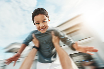 Image showing Family, speed and portrait of boy in air enjoying playing outdoors on holiday, vacation and weekend. Motion blur, childhood and happy face of boy in parents arms for bonding, quality time and relax